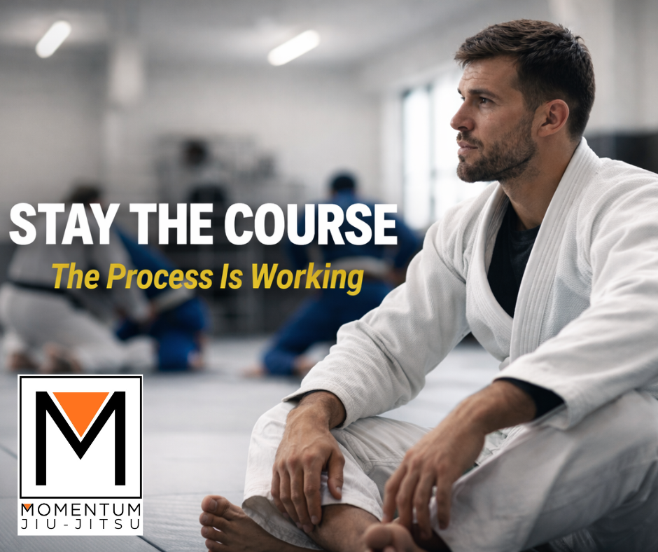 Adult jiu jitsu student resting calmly on the mat during training at Momentum Jiu Jitsu